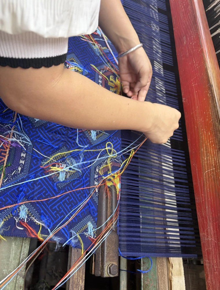 A master weaver at a traditional Zhuang loom