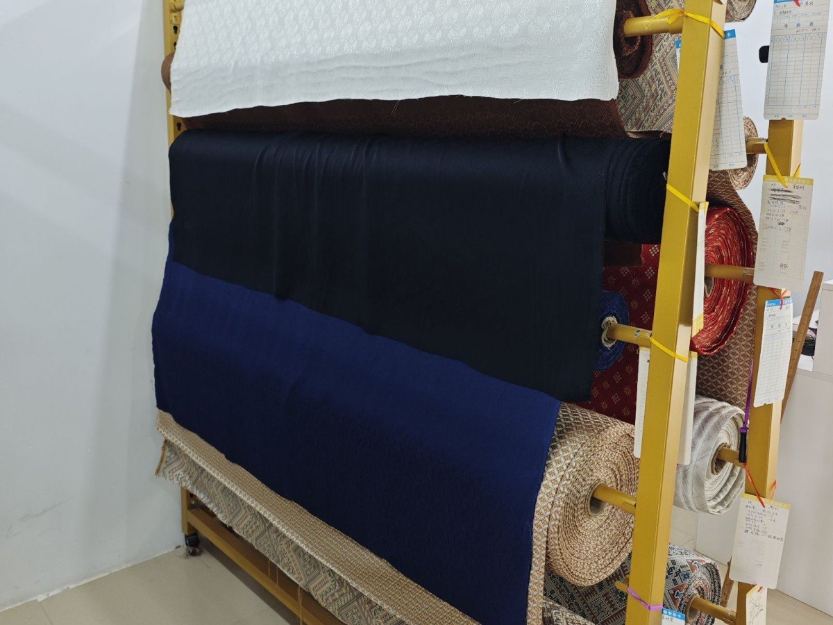Rolls of woven brocade fabric