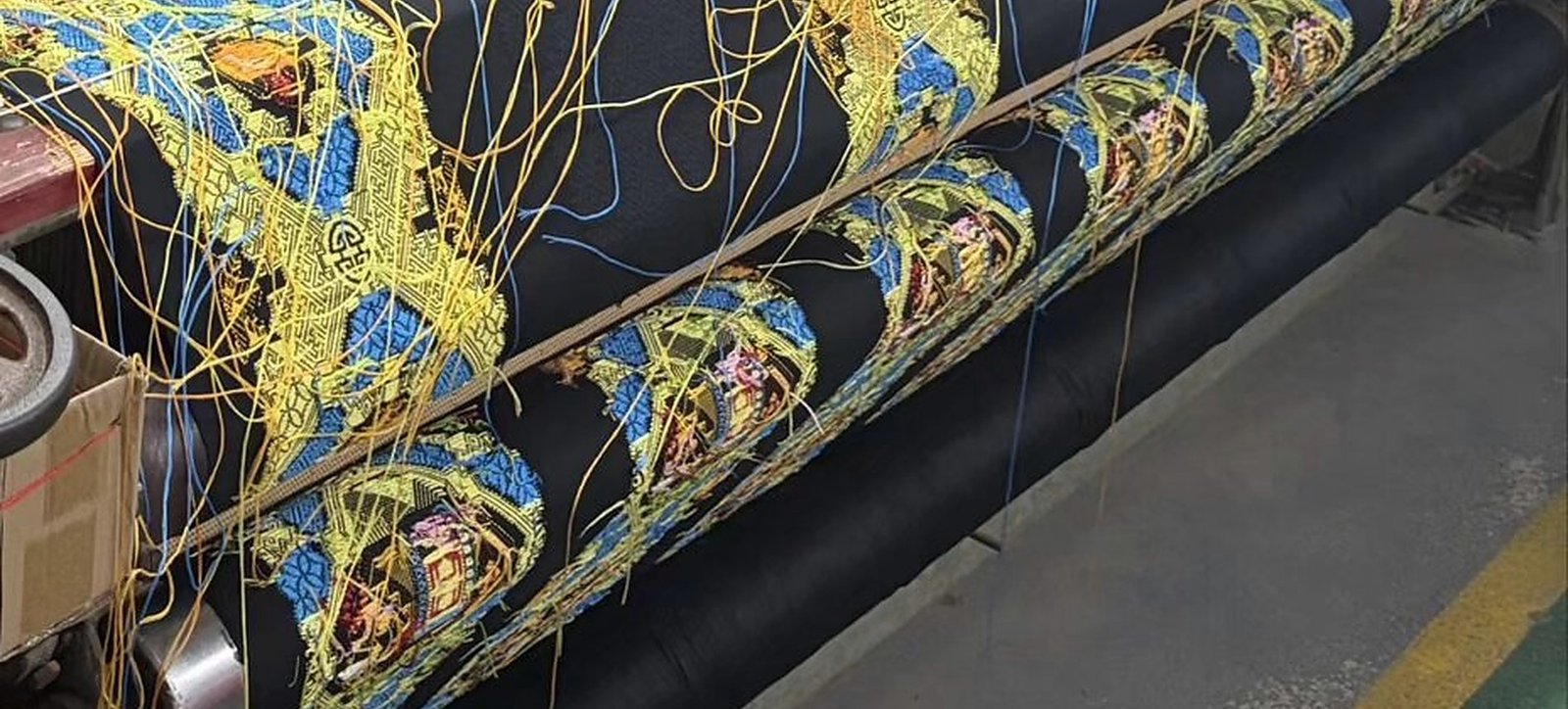 Rolls of Zhuang brocade fabric and sample swatches